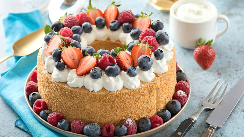 Angel food cake topped with mixed berries and whipped cream