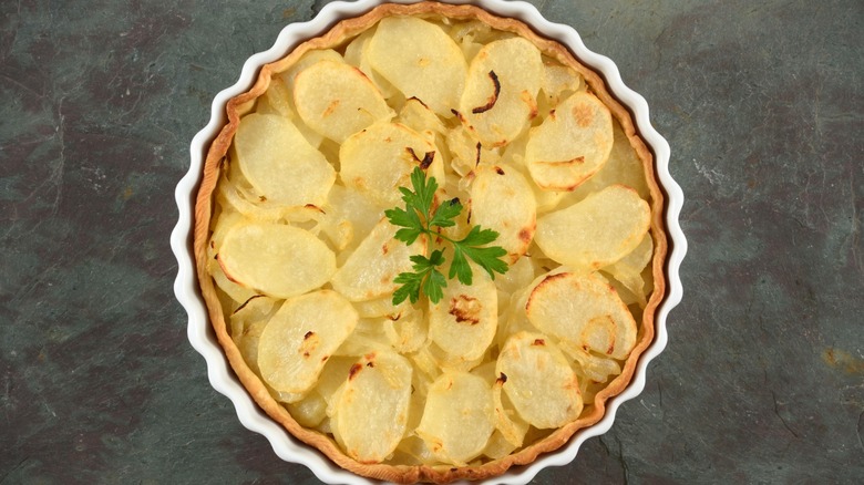 onion and potato savory pie on black slate