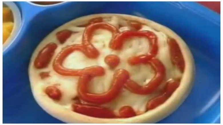 Box of Kid Cuisine Cheese Pizza Painter meal, showing a plastic tray with food including a cheese pizza with KC outlined in pizza sauce