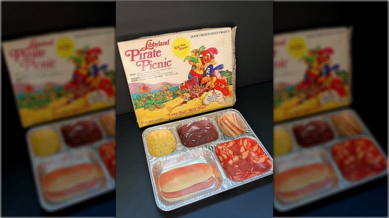 Box from Libbyland Pirate Picnic frozen dinner, with vintage tray and printed facsimiles of food in front