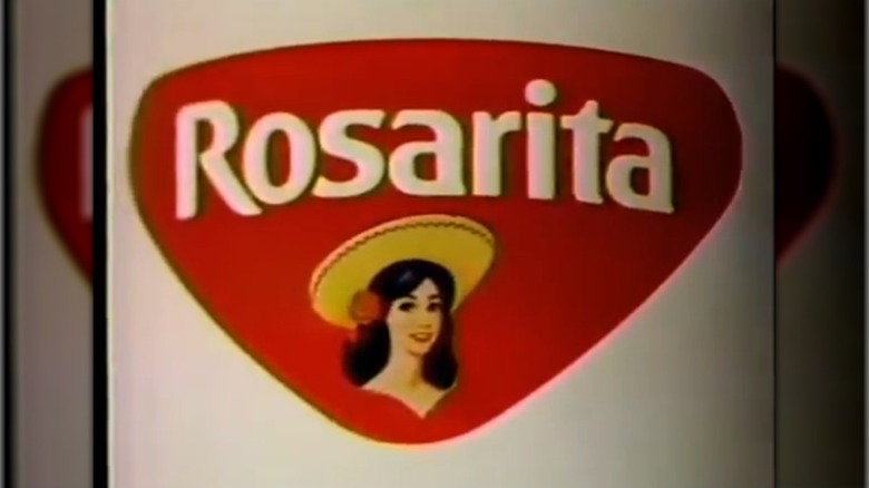 Rosarita food logo showing a cartoon of a young Mexican woman with a rose in her hair wearing a hat in front of red triangle with the word Rosarita in white