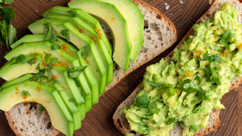 Two rustic toasts with avocados on top
