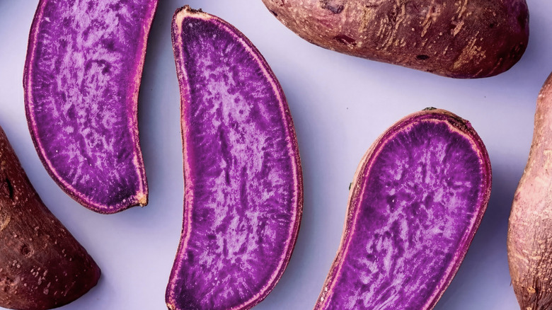 Ube halves sliced down the middle to reveal a vivid purple color