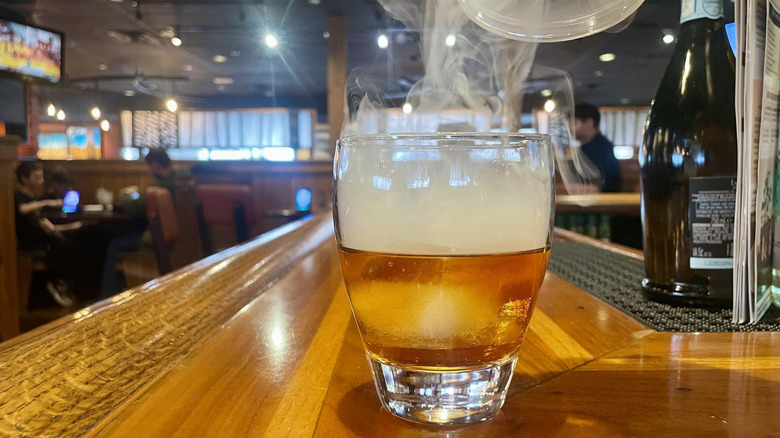 Outback Steakhouse's Smoked Old Fashioned with smoke wafting off the top