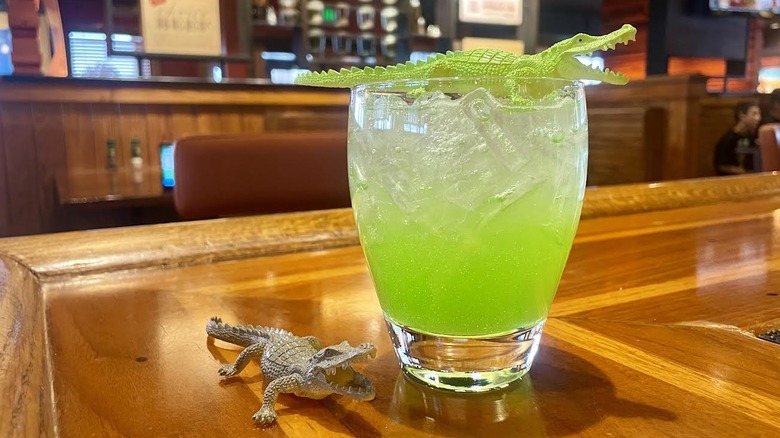 Outback Steakhouse's Croc-tail with toy crocodiles on a wooden bar top