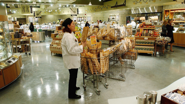 An employee restocking the Whole Foods Market bakery department