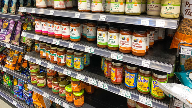 A shelf of dips and salsa at Whole Foods market