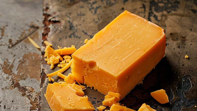 Block of cheddar cheese on counter