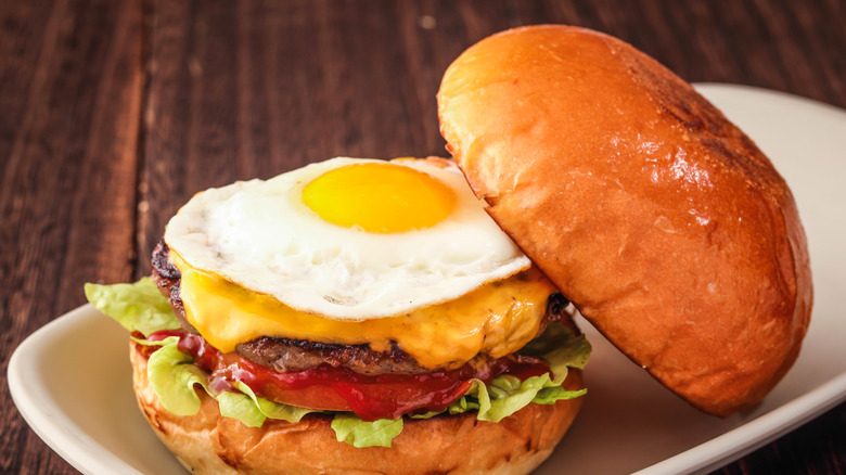 Sunny side up egg on cheeseburger