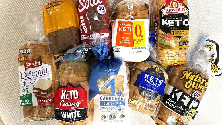 Nine bags of keto breads arranged on a table.