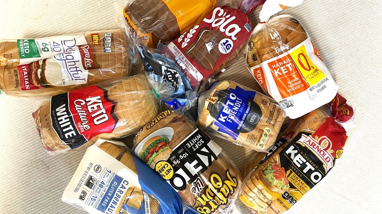Nine keto breads arranged on a table.