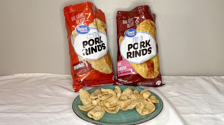 Two bags of Great Value pork rinds with rinds on a green plate