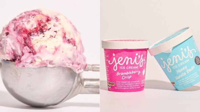 Two Jeni's ice cream pints balanced on a table, one vanilla flavor in a light blue tub and the other brambleberry crisp in a hot pink tub, and a scoop of brambleberry ice cream