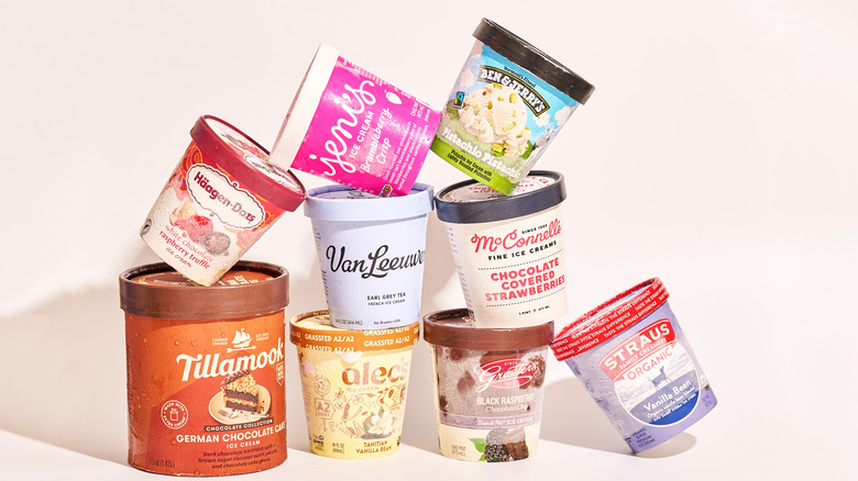 Nine pints of ice cream from various brands stacked on a table