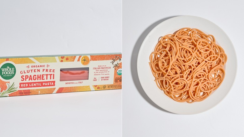 Box of red lentil spaghetti next to a plate of cooked spaghetti.