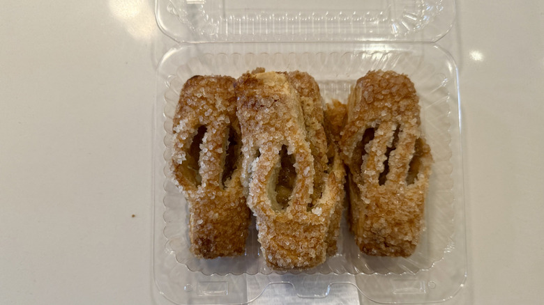 Mini apple streusel in clear plastic container on a white table