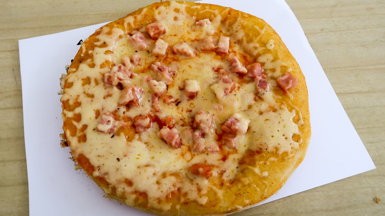 simple Cuban pizza with melted gouda and ham sitting on a counter