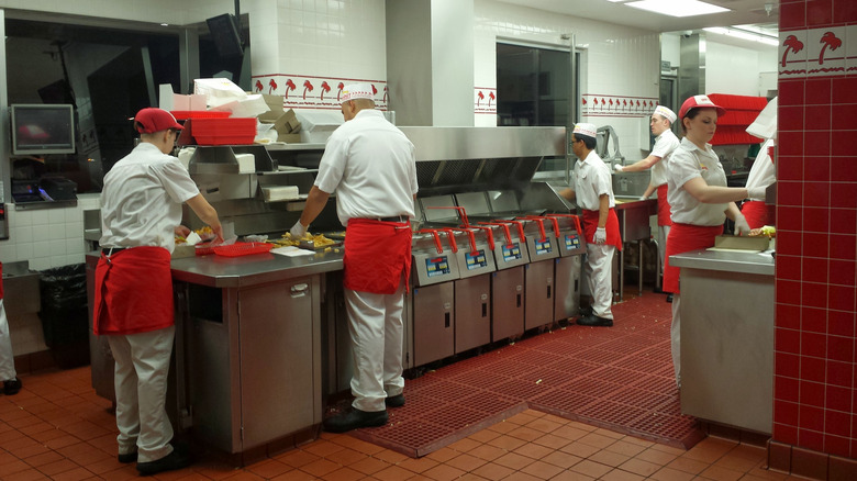 View of kitchen at an In-N-Out showing workers preparing food