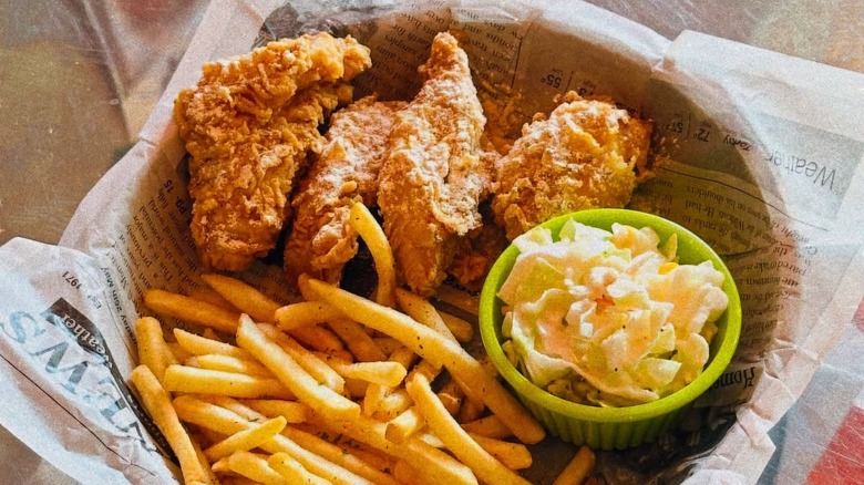 A basket of fried chicken, coleslaw, and fries from Noori Chicken