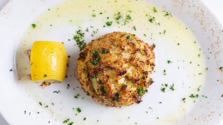 A crab cake on a plate at Rizzuto's Ristorante & Chop House
