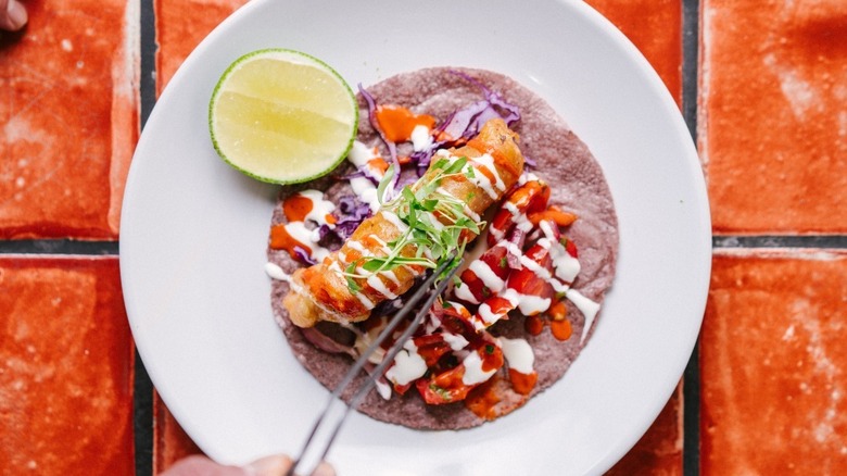 A Baja fish taco on a plate at Holbox