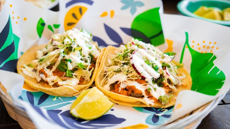 Two fish tacos on a plate at Cholita Linda