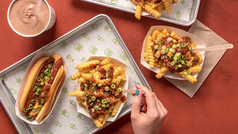 An aerial view of the now discontinued Shake Shack Chili series, featuring the Sport Pepper Cheese Fries in the center