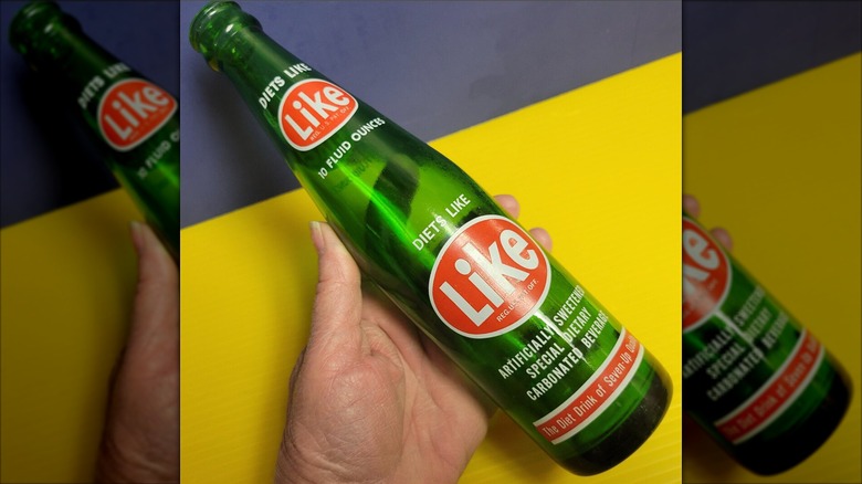 Hand holding a bottle of Like Soda