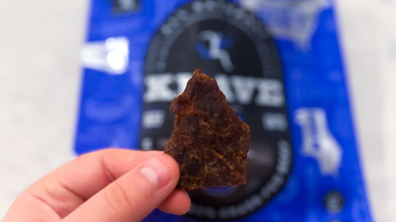 A strip of Krave jerky against its package