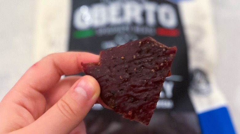 A strip of Oberto jerky against its package