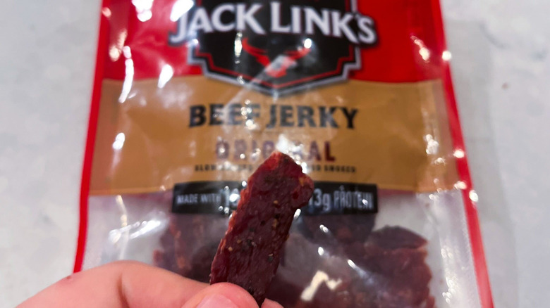 A strip of Jack Link's jerky against its package