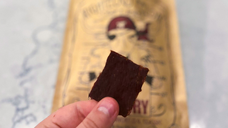 A strip of Righteous Felon jerky against its package