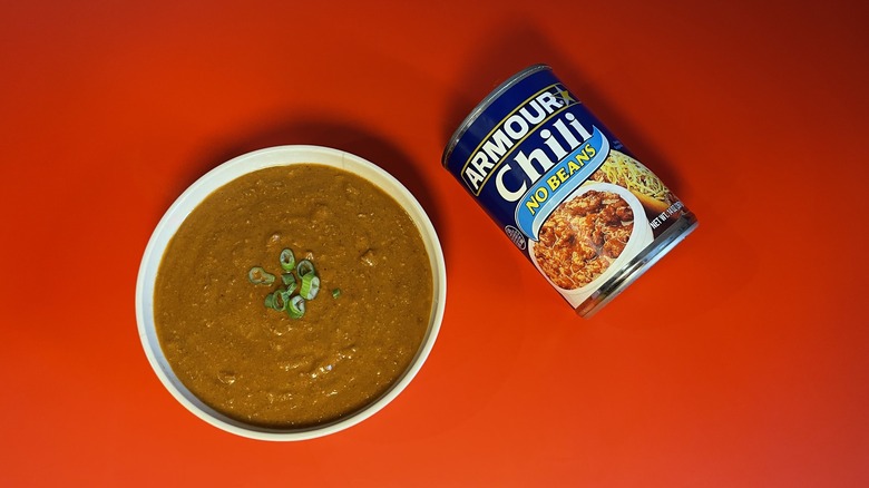 A can of Armour chili next to a bowl of chili