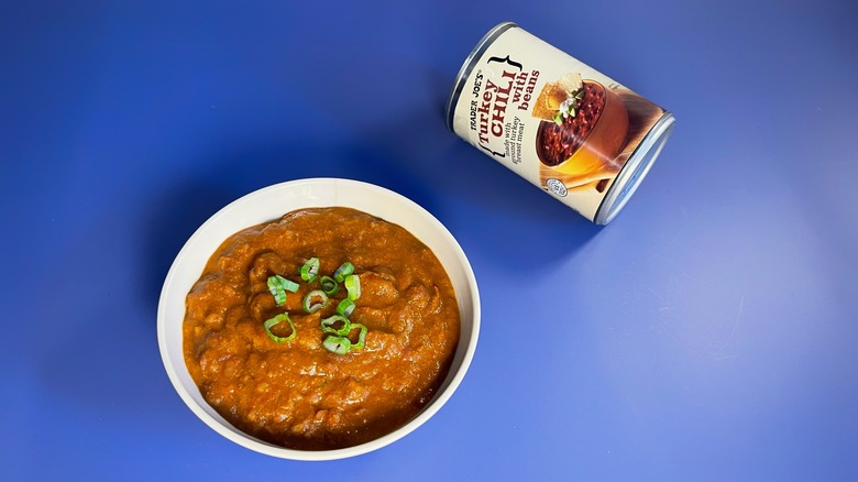 A can of Trader Joe's chili next to a bowl of chili