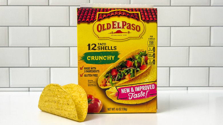 A box of Old El Paso crunchy taco shells, with a shell outside the box on the left side