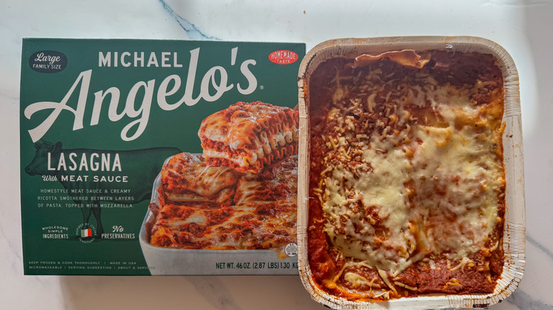 Lasagna with packaging on marble surface