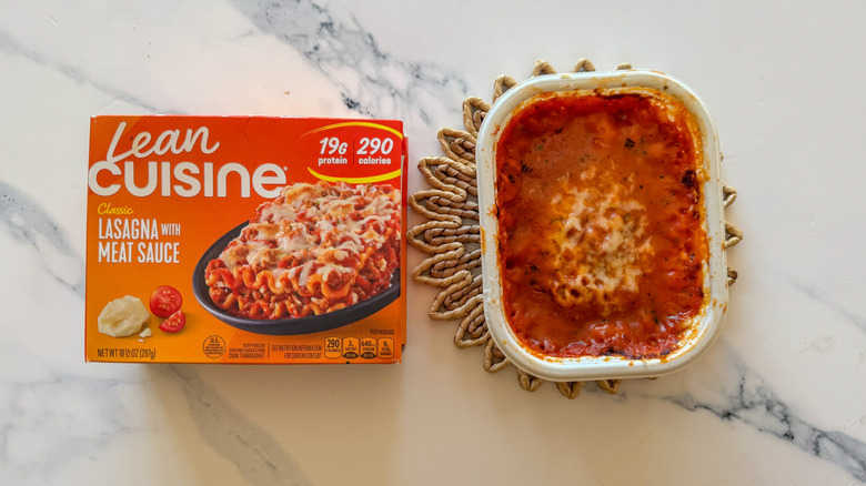 Lasagna with packaging on marble surface