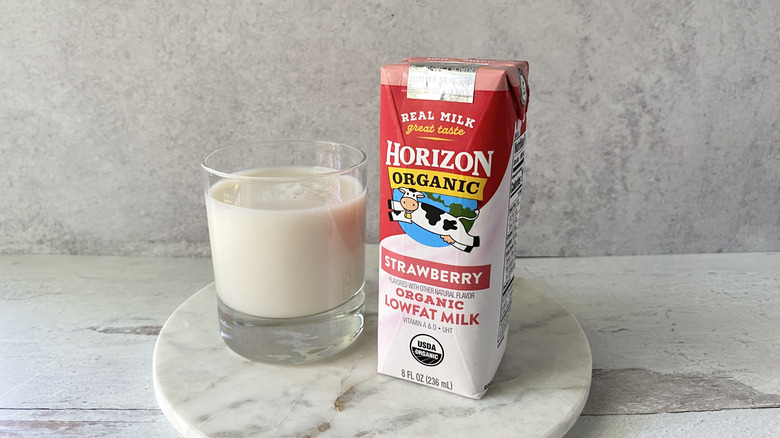Horizon Organic Strawberry Organic Low-Fat Milk in the original packaging and in a glass on a white marble coaster