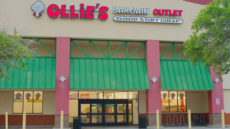 The storefront of an Ollie's store with green shutters