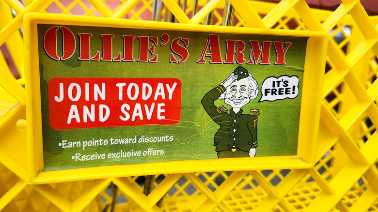 An Ollie's Bargain Outlet shopping cart with an advertisement for Ollie's Army loyalty program