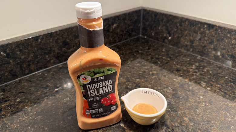 Bottle and small bowl of Stop & Shop Thousand Island Dressing on black countertop