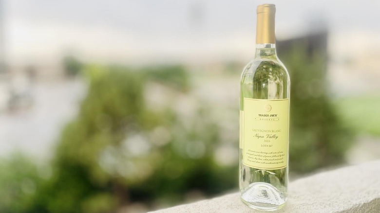 A bottle of Trader Joe's Reserve Sauvignon Blanc Lot #267 sitting on outdoor ledge