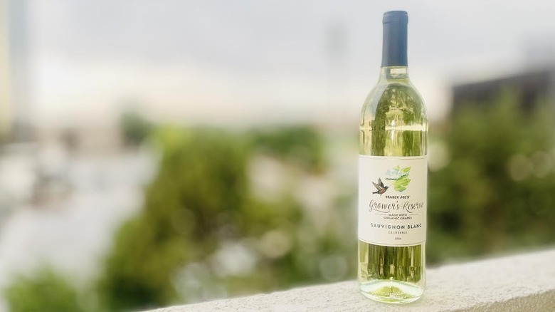 A bottle of Trader Joe's Grower's Reserve Organic Sauvignon Blanc sitting on an outdoor ledge