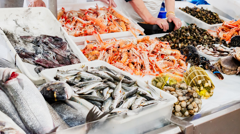 outdoor seafood market with various types of seafood
