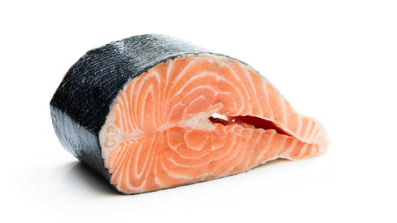 single salmon steak on white isolated background