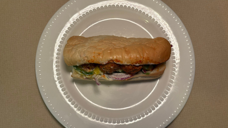 A Philly cheesesteak sub with meatballs on white bread