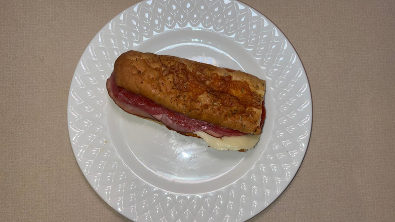 A sub on Italian herbs and cheese bread with Italian meats and provolone
