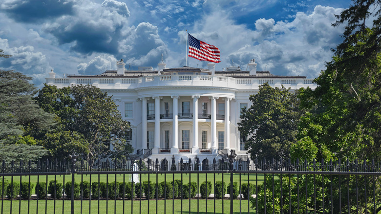 The front of the White House on a partly cloudy day