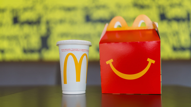 A McDonald's Happy Meal and a drink on a table