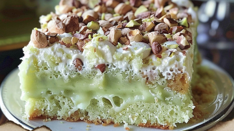 a close up picture of a piece of pistachio pudding cake on a white plate
